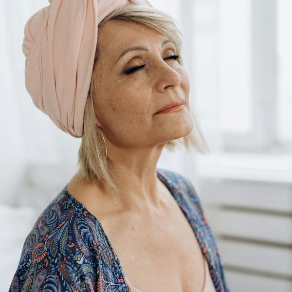 A child with eyes closed and a peaceful smile, meditating.