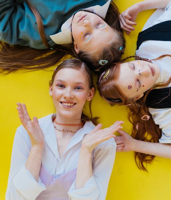 Happy child doing a playful yoga pose in a bright and colorful room.